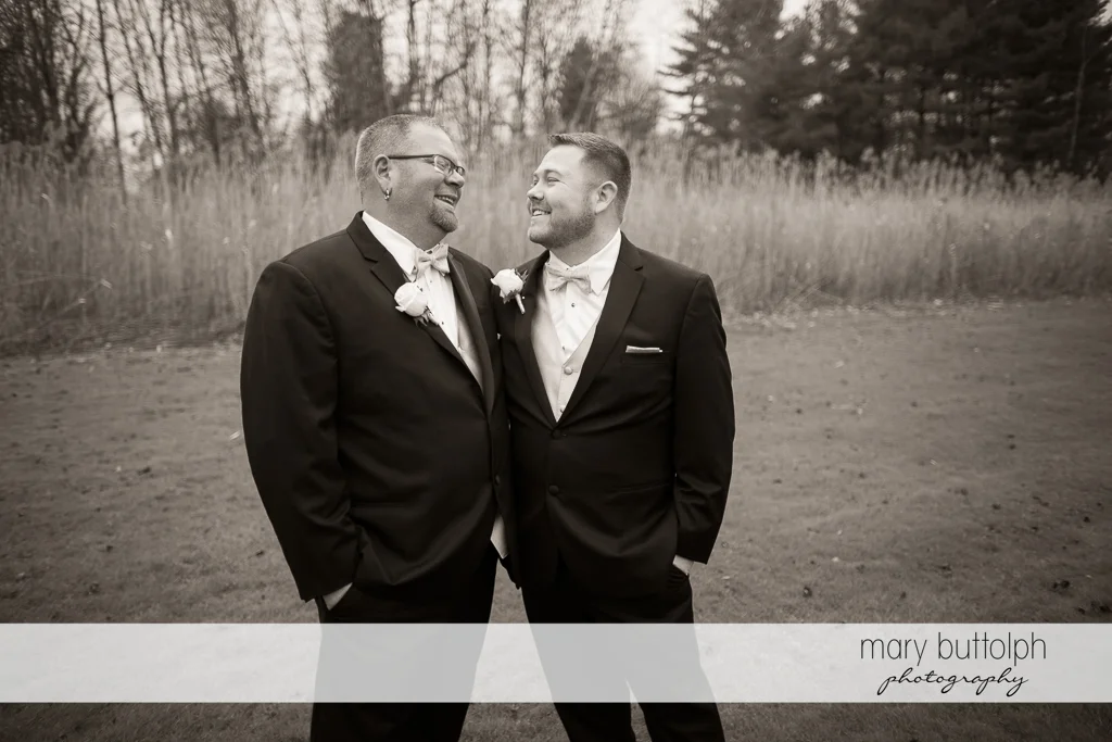 Same sex couple pose in the woods at SArrowhead Lodge Wedding
