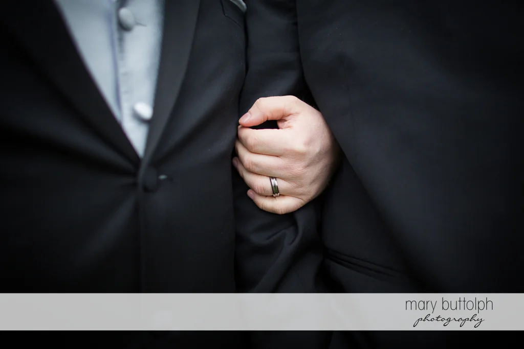 Groom holds his partner's arm at Arrowhead Lodge Wedding