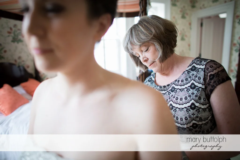 Bride and her mom prepare for the event at the Inns of Aurora Wedding