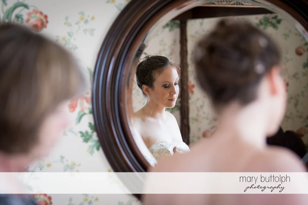 Bride's mirror image is seen in this shot at the Inns of Aurora Wedding