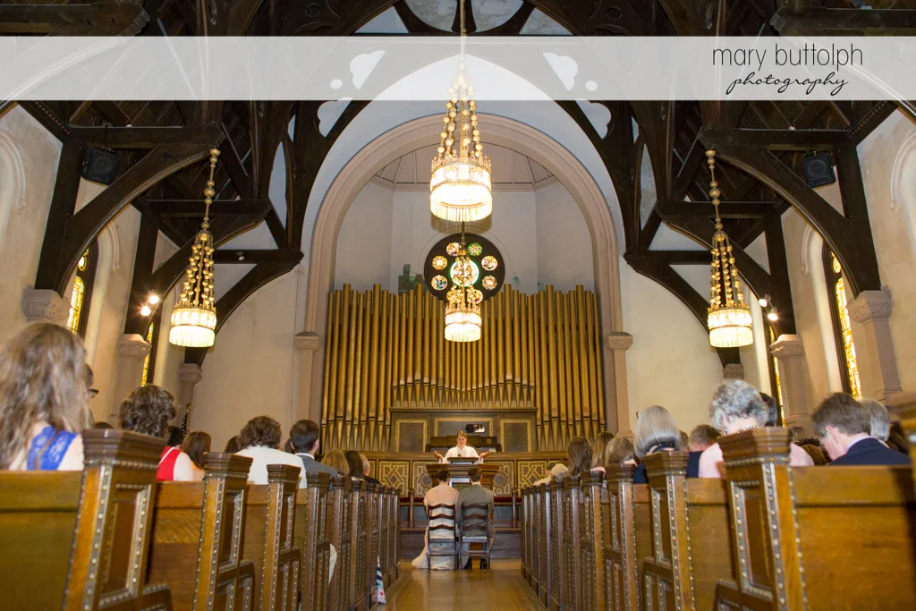 Long shot of the couple in front of the altar at the Inns of Aurora Wedding