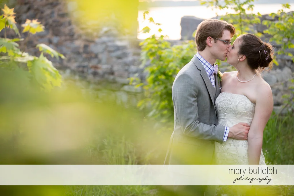 Couple share a tender moment in the ruins at the Inns of Aurora Wedding