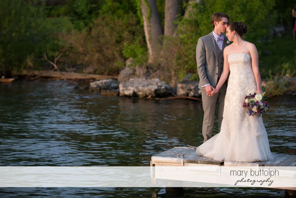 Couple pose by the lake at the Inns of Aurora Wedding