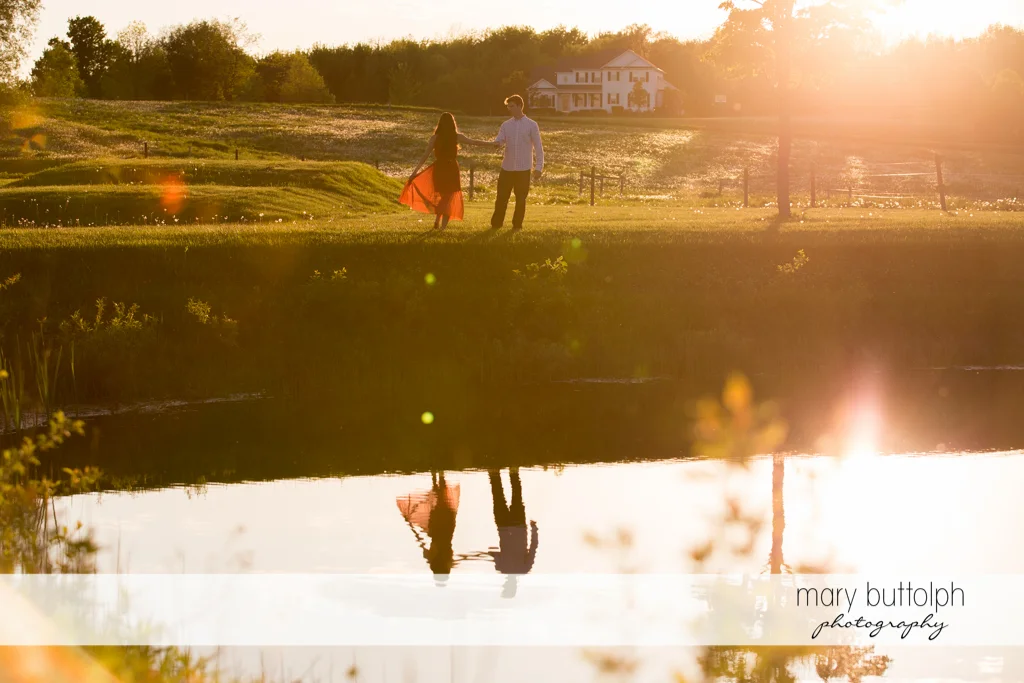 Couple take a break near the lake at Skaneateles Engagement