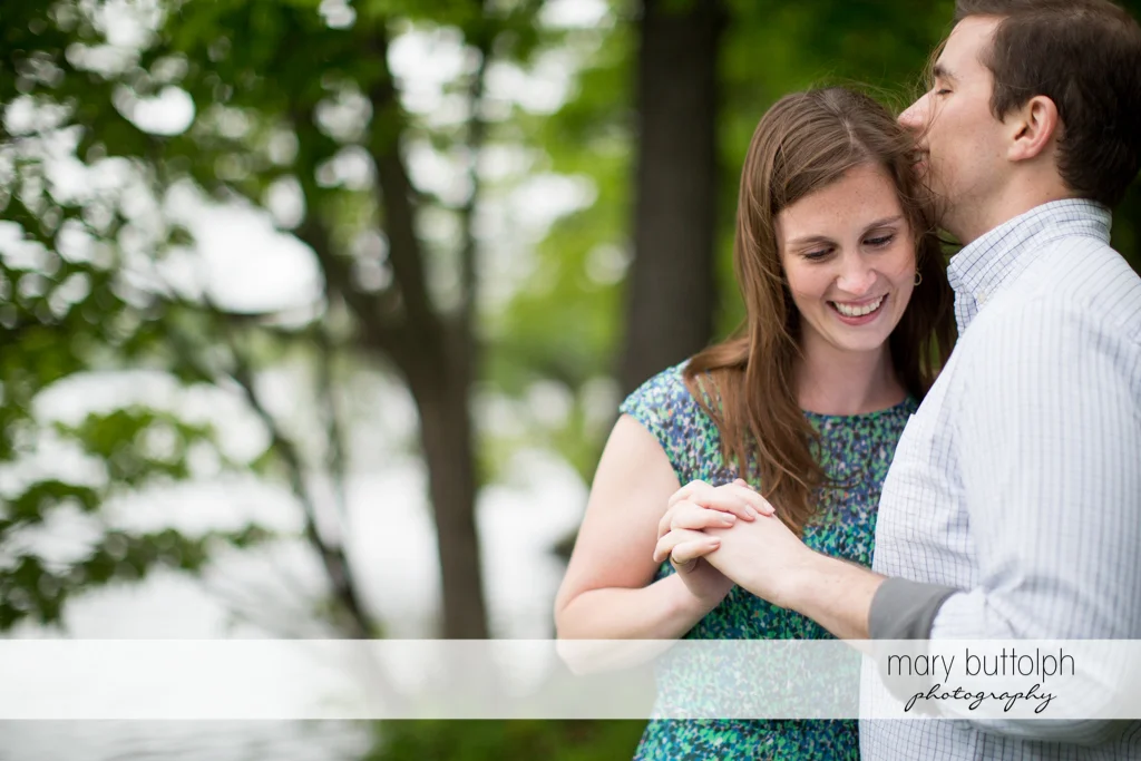 Couple pose near trees by the lake at the Hamilton Inn Engagement