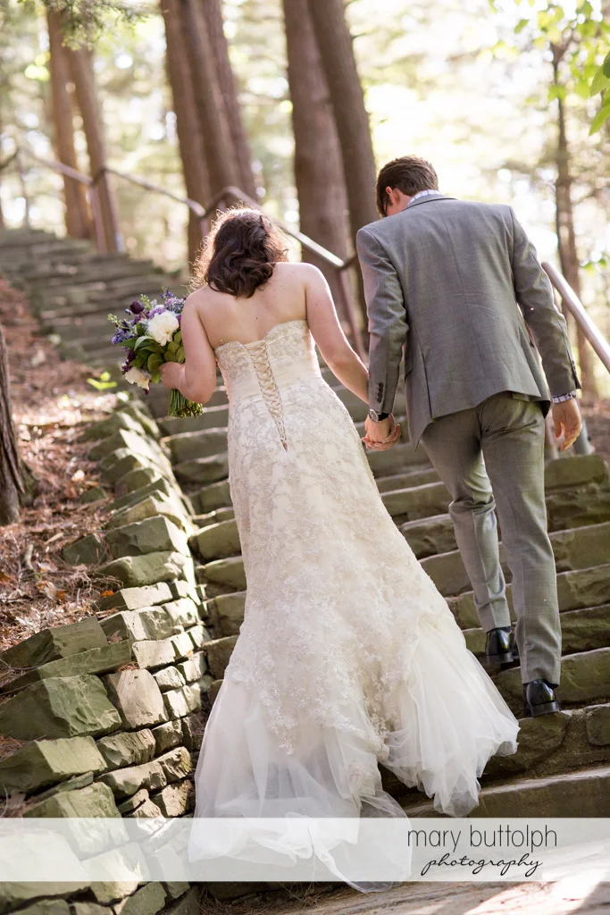 Couple climb the stone steps at Taughannock Falls Wedding