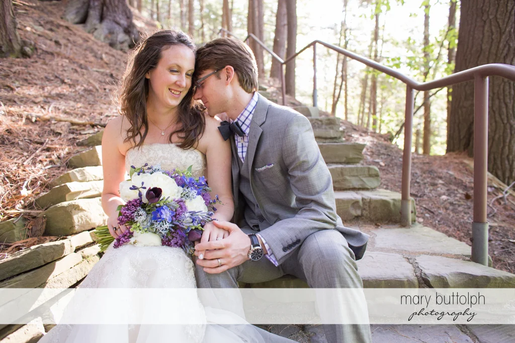 Couple relax on the stone steps at Taughannock Falls Wedding