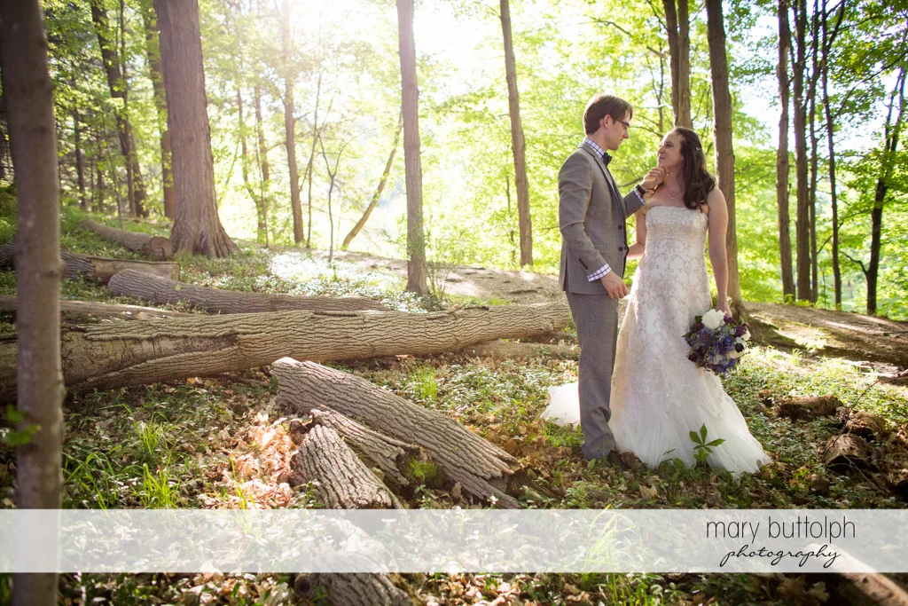 Couple share a tender moment in the woods at Taughannock Falls Wedding