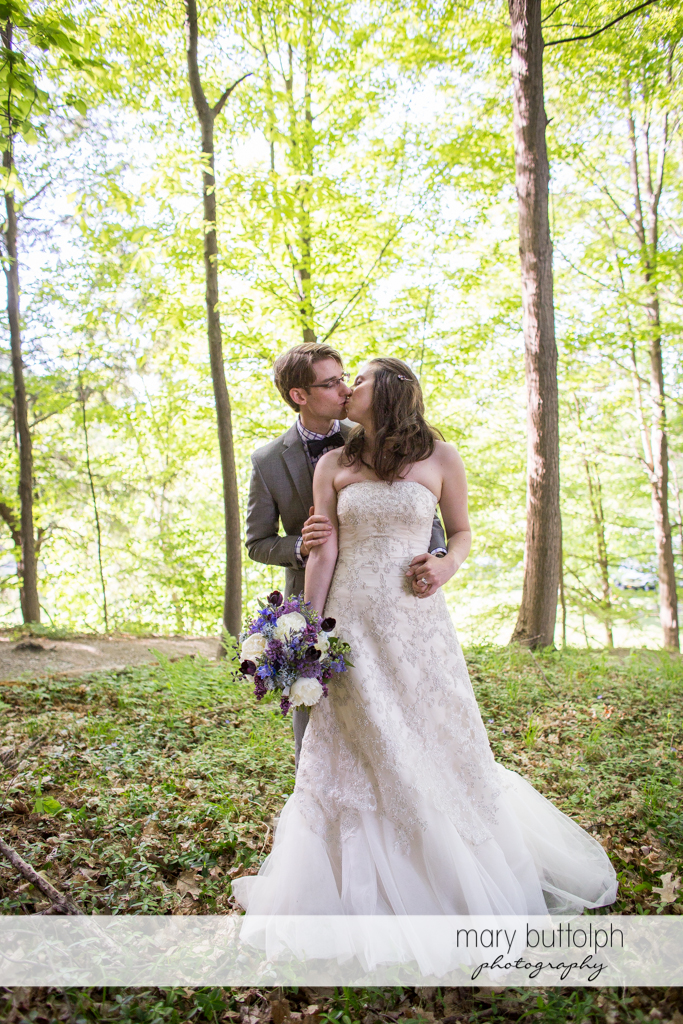 Couple kiss in the woods at Taughannock Falls Wedding