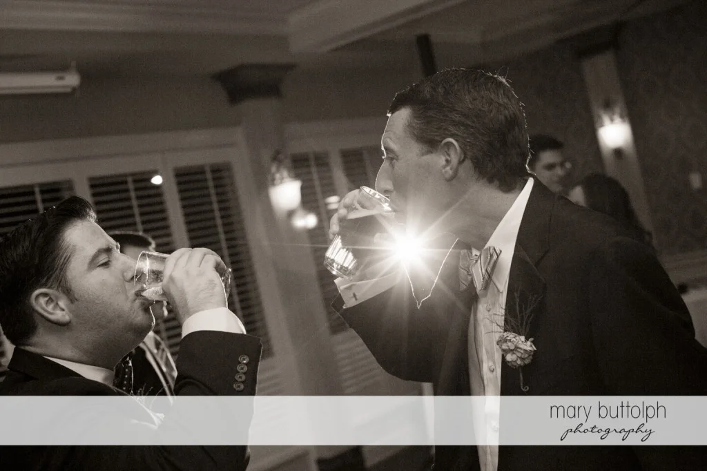 Groom and friend have a drink at Skaneateles Country Club Wedding