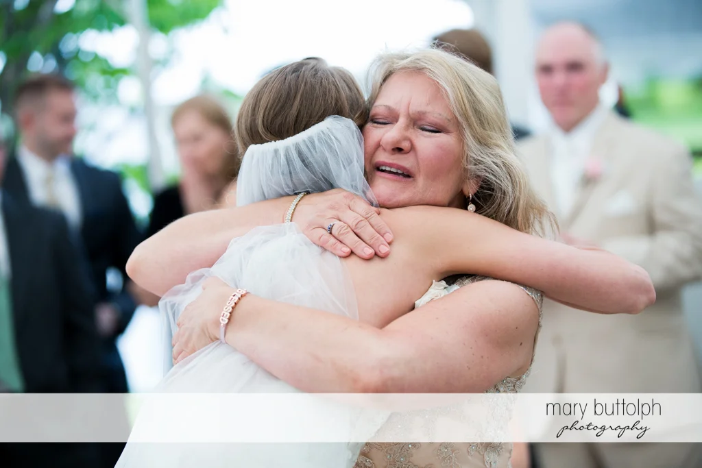 Bride hugs her mother at the Inns of Aurora Wedding