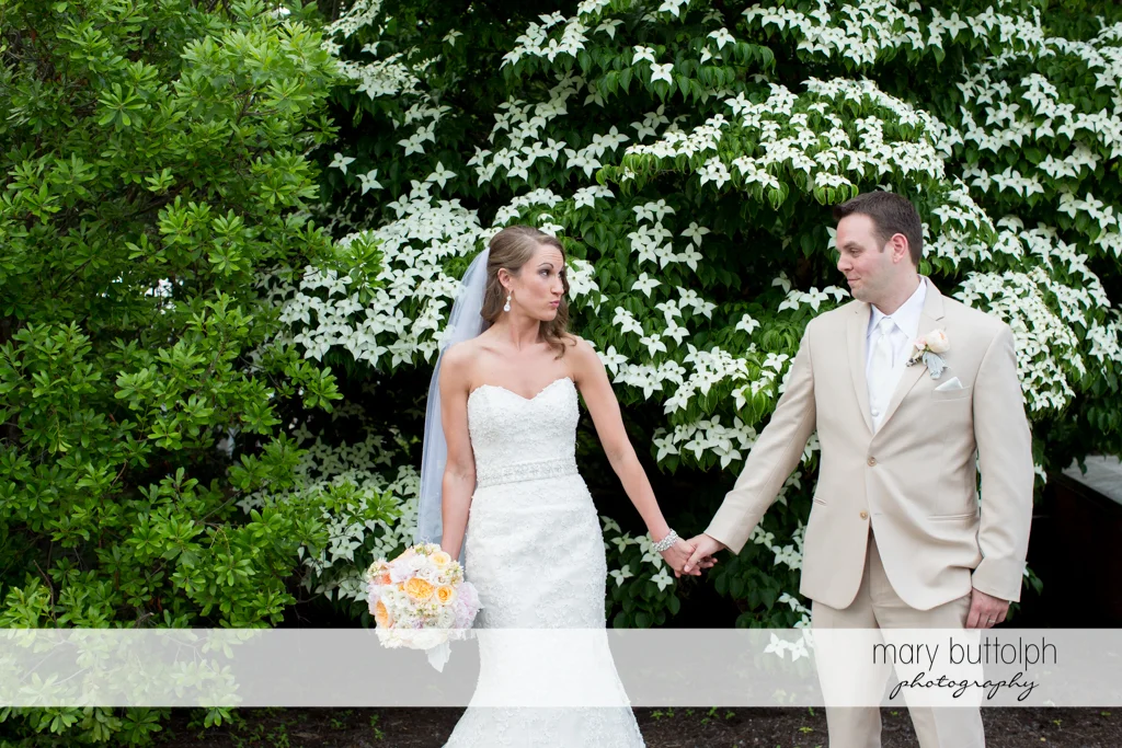 Couple hold hands in the garden at the Inns of Aurora Wedding