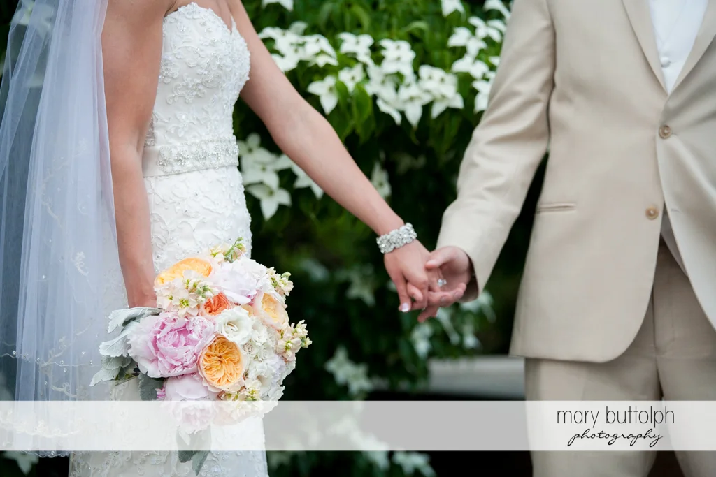 Another shot of the couple holding hands in the garden at the Inns of Aurora Wedding