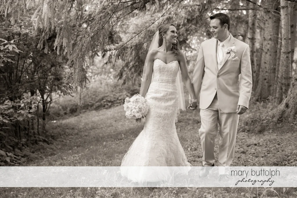 Couple stroll in the woods at the Inns of Aurora Wedding