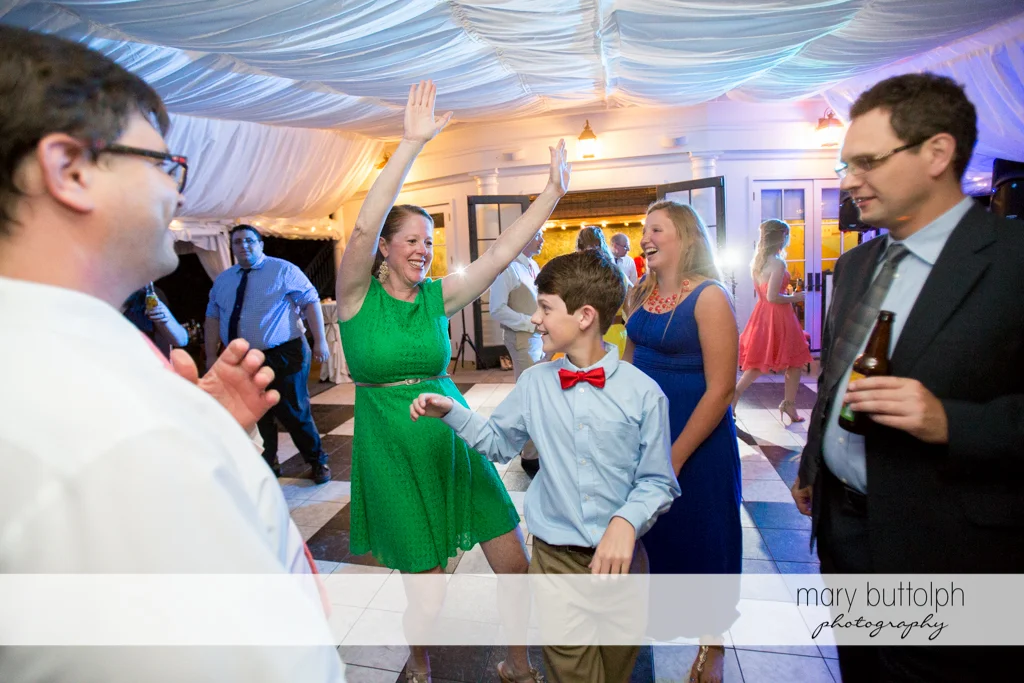 Young man joins other guests on the dance floor at the Inns of Aurora Wedding