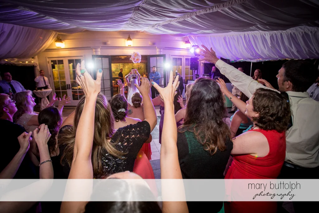 Bride throws the bouquet to the women at the Inns of Aurora Wedding