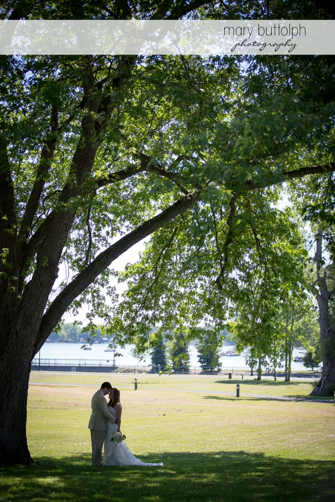 Couple rub noses under a big tree at Emerson Park Pavilion Wedding