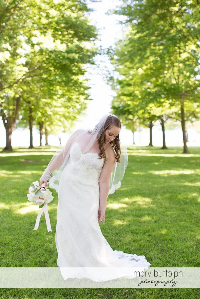 Bride poses in the garden at Emerson Park Pavilion Wedding