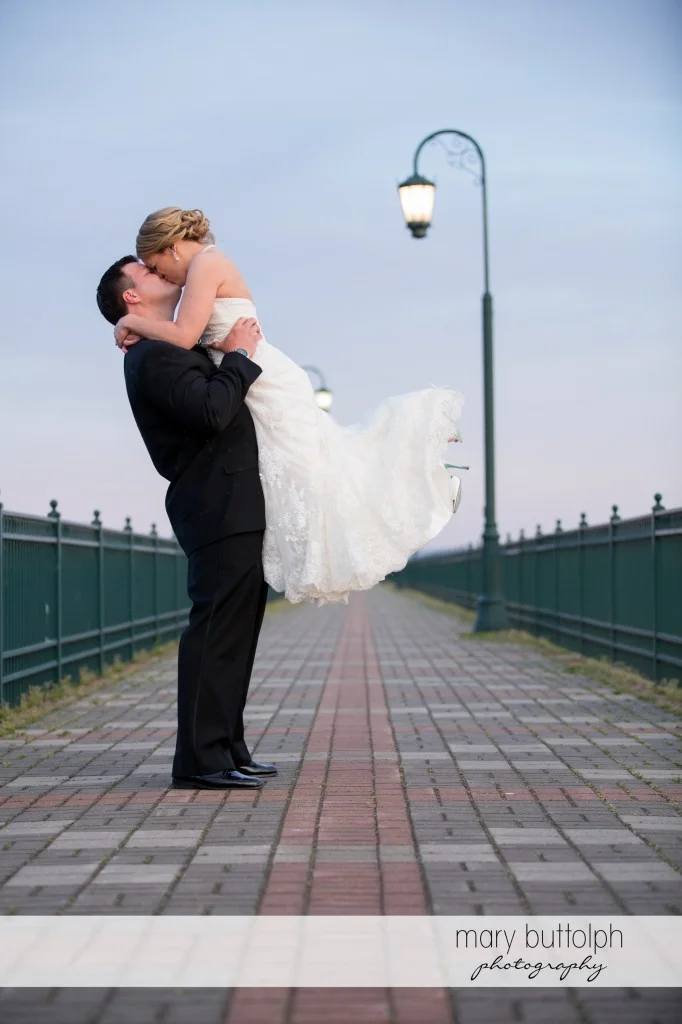 Couple kiss on the walkway at Emerson Park Pavilion Wedding