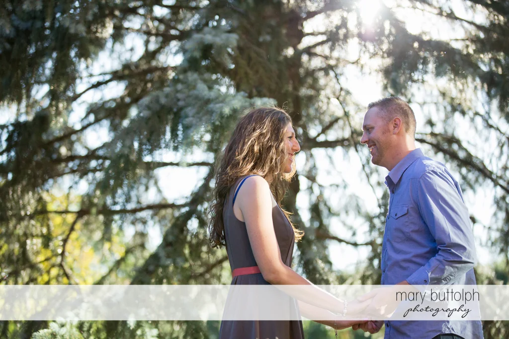 Couple face each other in the garden at Franklin Square Engagement