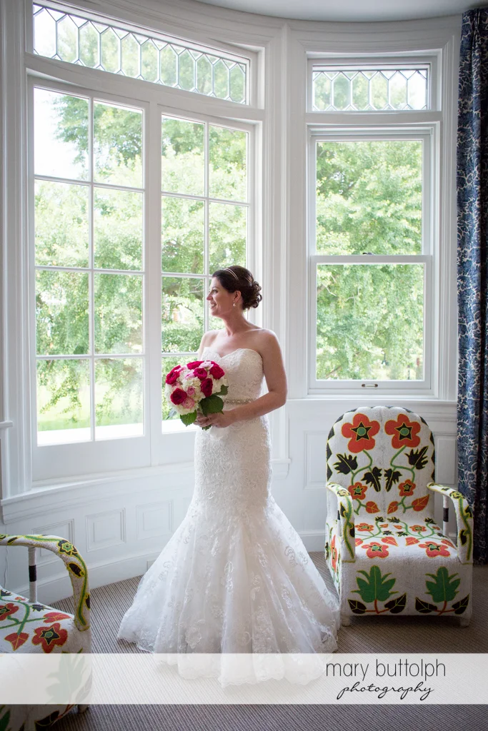 Bride admires the view outside at the Inns of Aurora Wedding