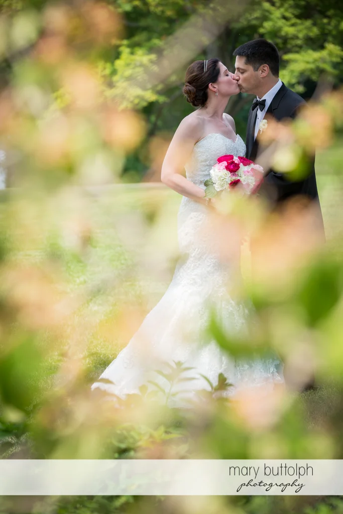 Couple kiss in the garden at the Inns of Aurora Wedding