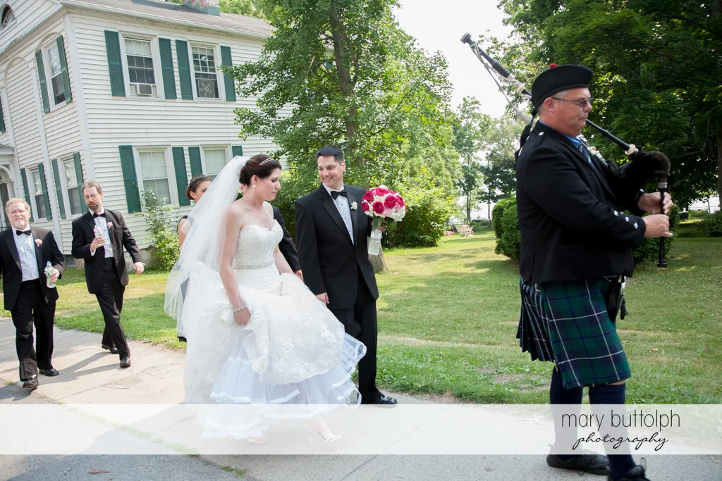 Bagpipe player leads the way for the wedding party at the Inns of Aurora Wedding