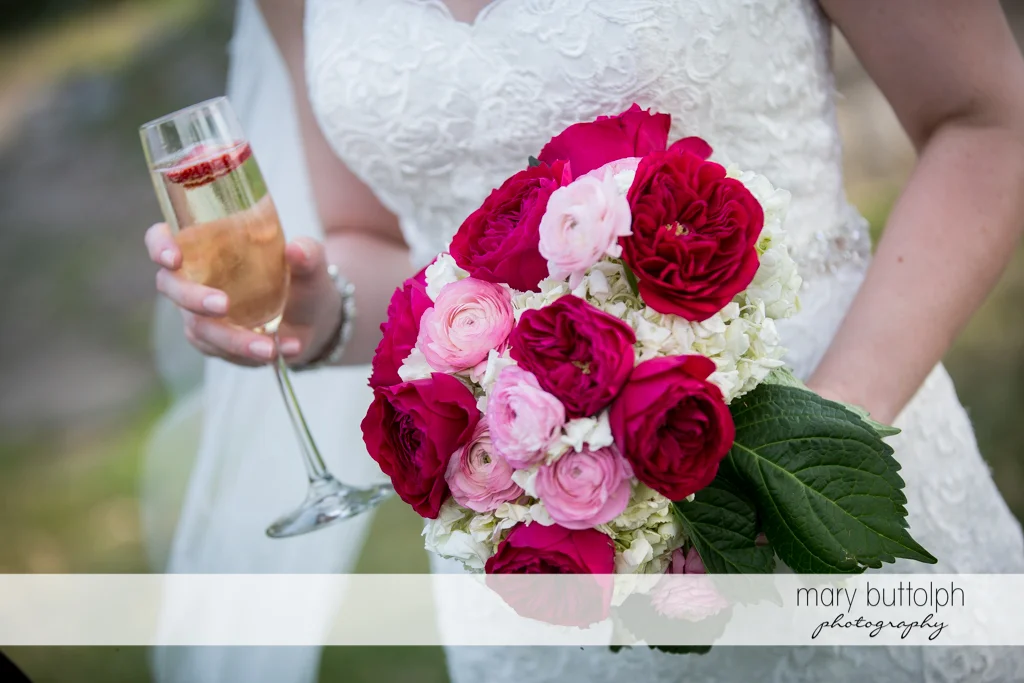Close up shot of the bride's bouquet and glass of wine at the Inns of Aurora Wedding