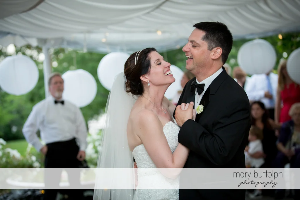 Couple laugh while dancing at the Inns of Aurora Wedding