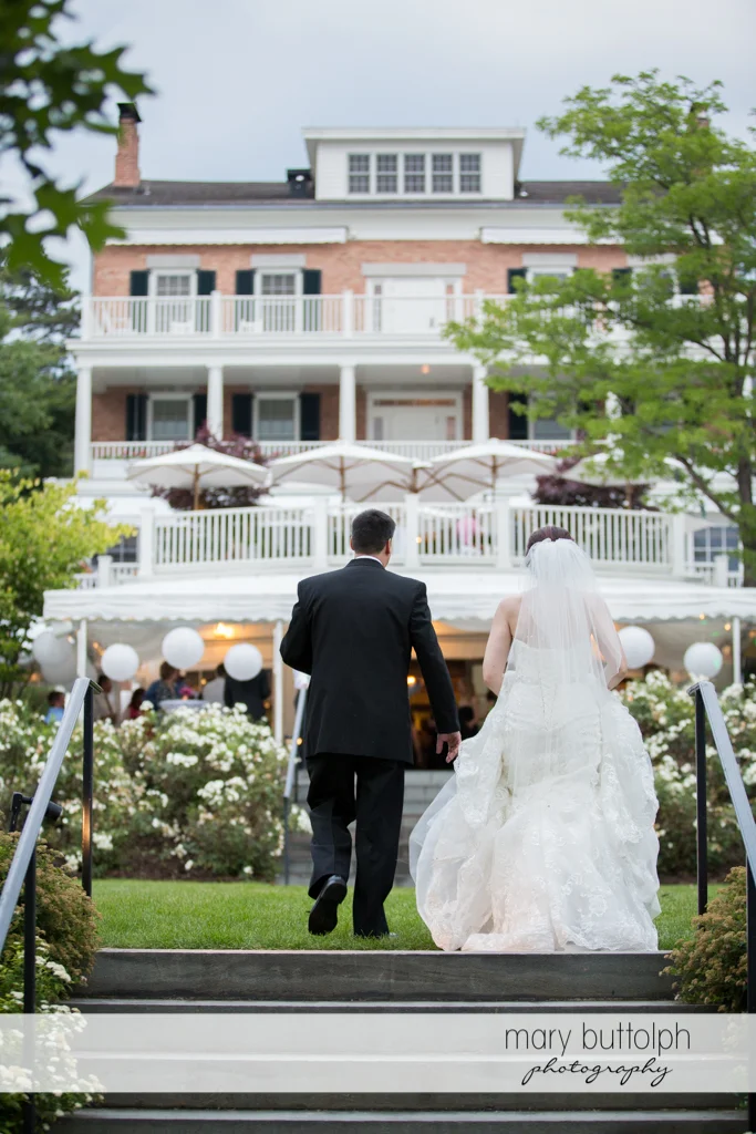 Couple approach the wedding venue at the Inns of Aurora Wedding
