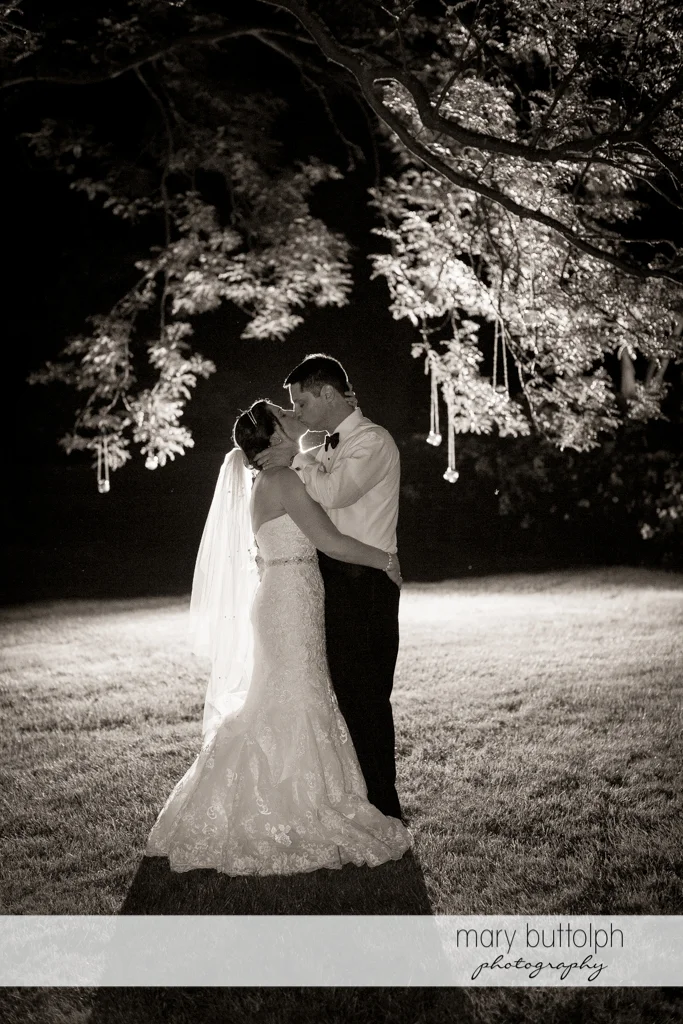 Couple kiss in the moonlight at the Inns of Aurora Wedding