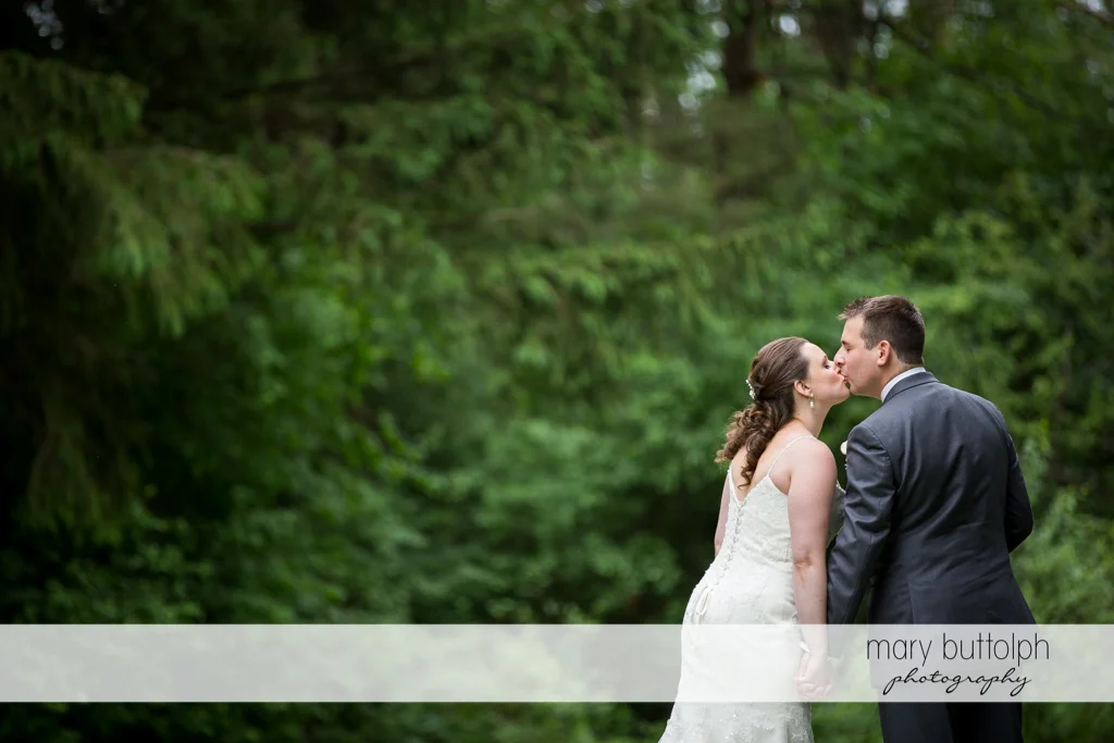 Couple in a romantic mood in the woods at the Mirbeau Inn & Spa Wedding