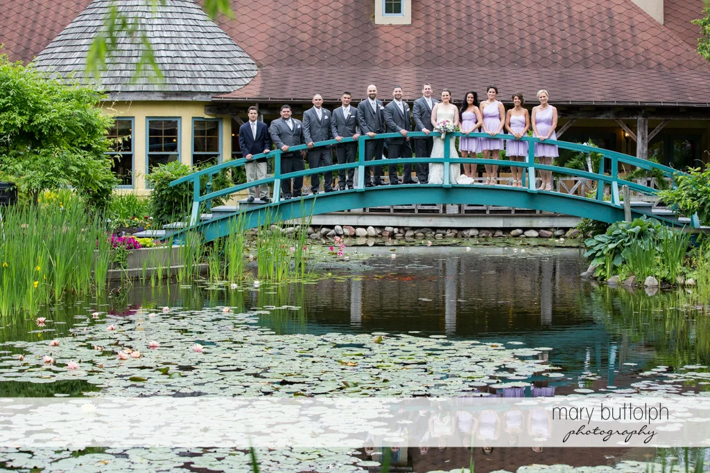 The wedding party on the wooden bridge at the Mirbeau Inn & Spa Wedding