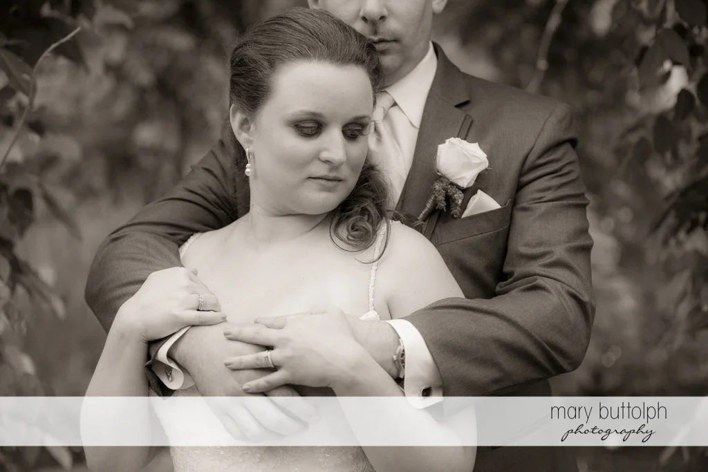 Couple in loving embrace at the Mirbeau Inn & Spa Wedding
