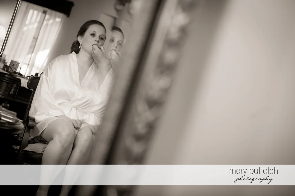 Bride's reflection in the mirror at the Mirbeau Inn & Spa Wedding