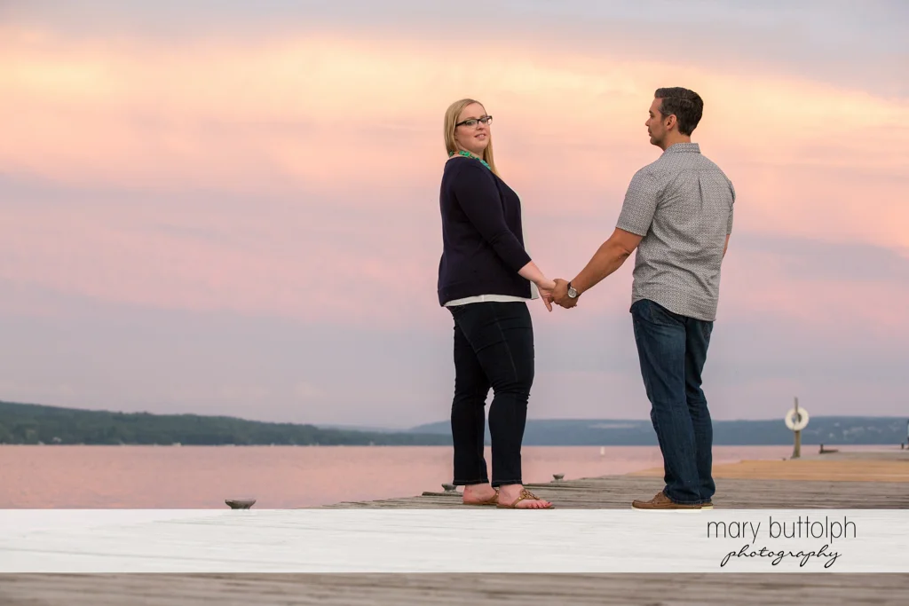 Couple stand near the lake at Skaneateles Engagement
