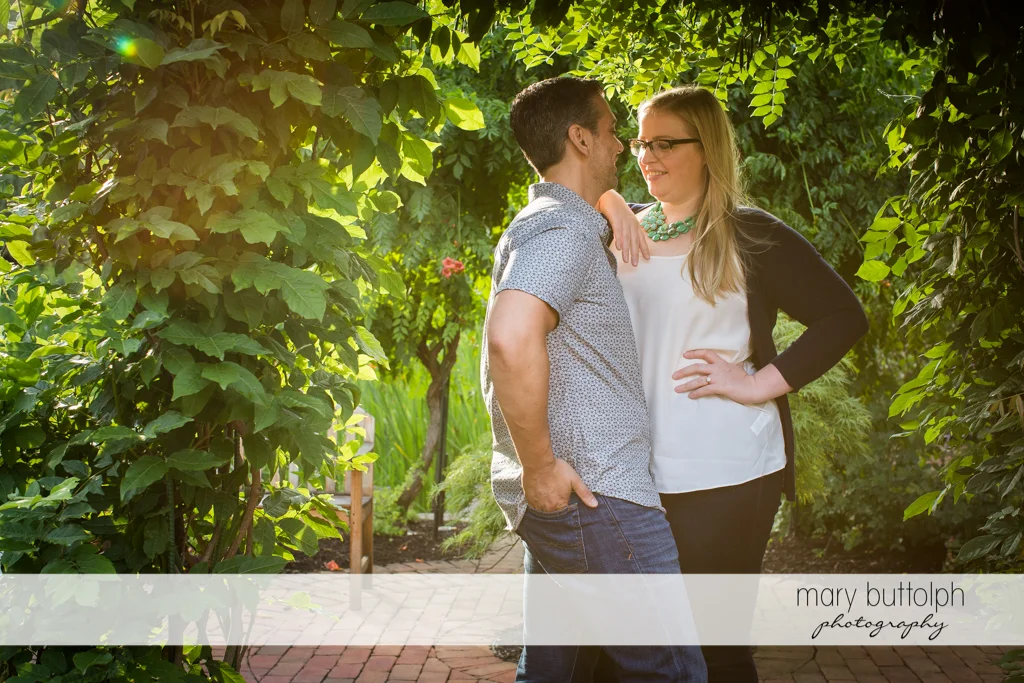 Couple share a quiet moment in the garden at Skaneateles Engagement