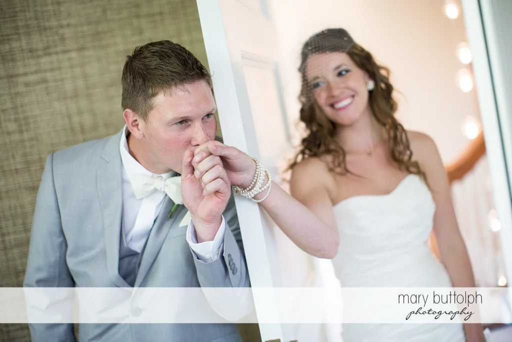 Groom kisses the bride's hand at the Inns of Aurora Wedding