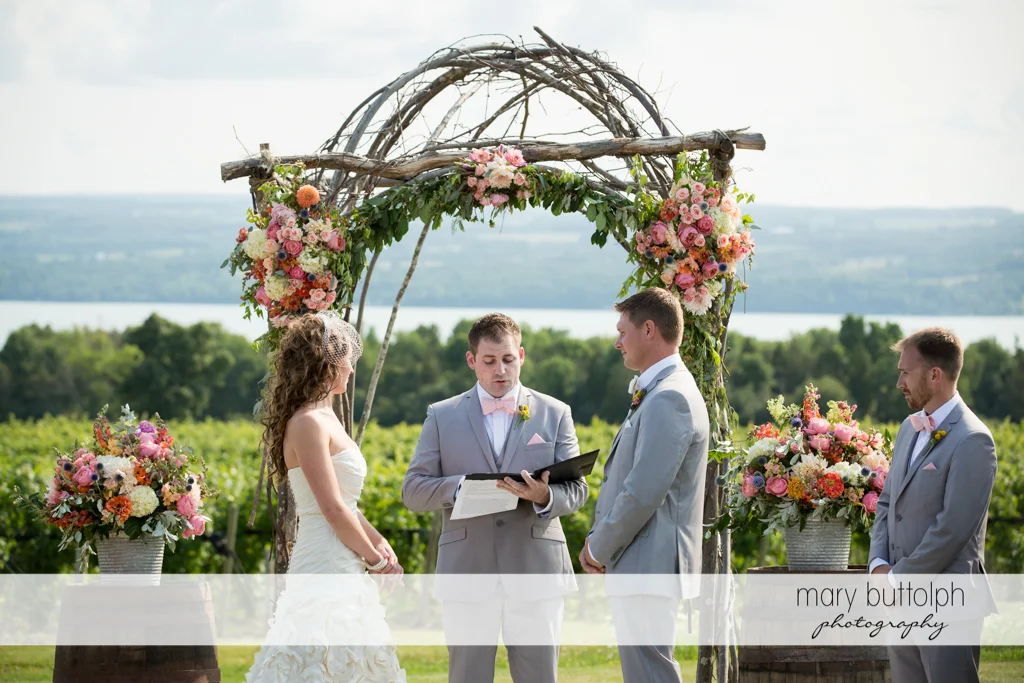 Couple face the wedding officiant in the garden at the Inns of Aurora Wedding