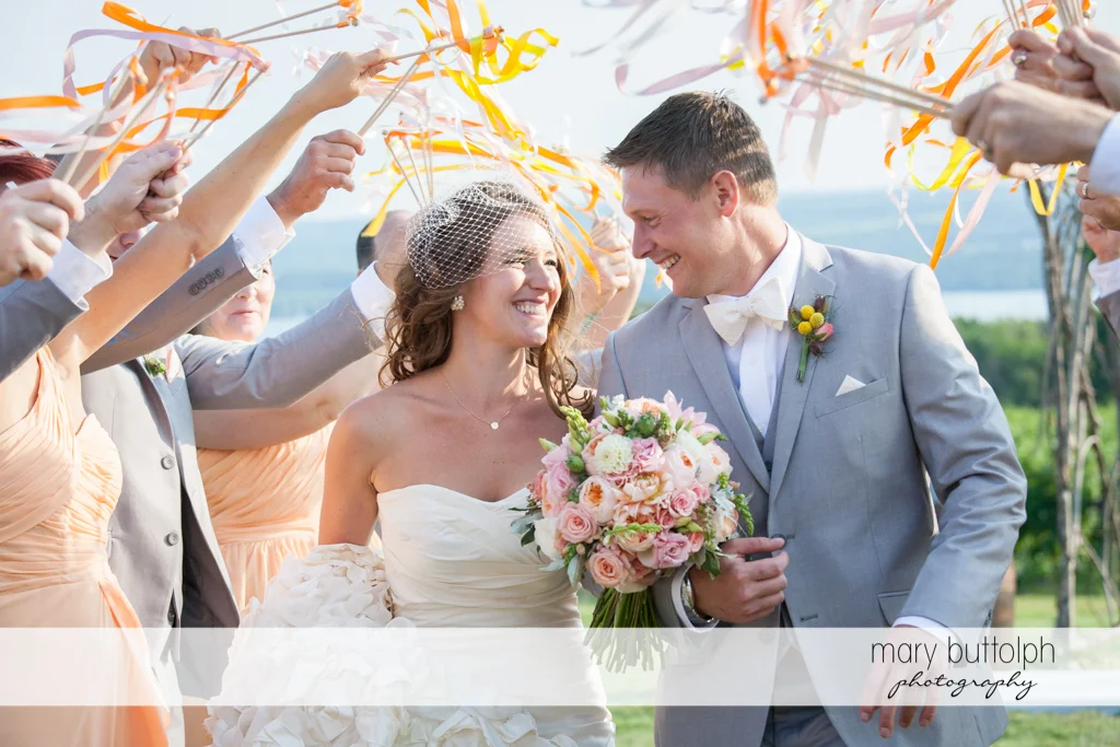 Guests ring bells for the couple after the wedding at the Inns of Aurora Wedding