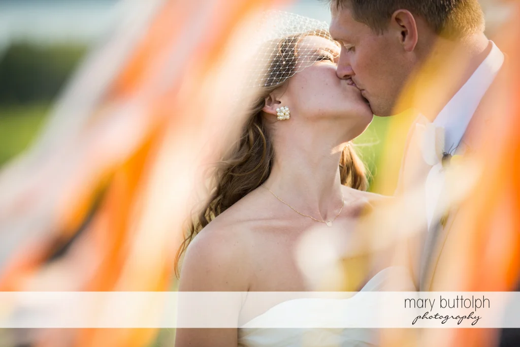 Couple kiss after the wedding ceremony in the garden at the Inns of Aurora Wedding