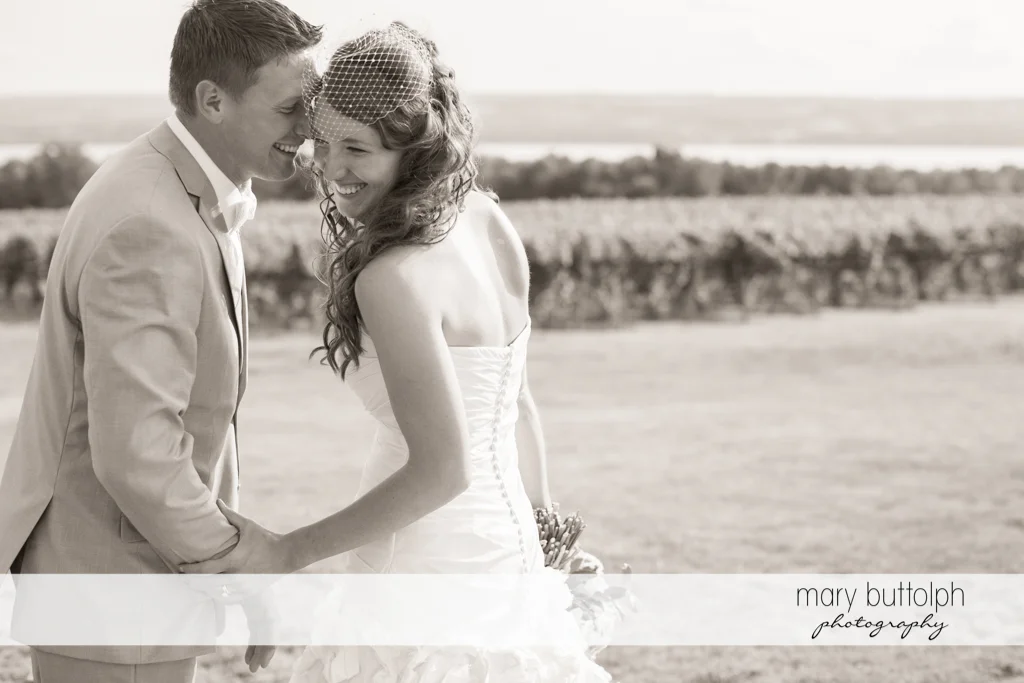 Happy couple stroll in the garden at the Inns of Aurora Wedding