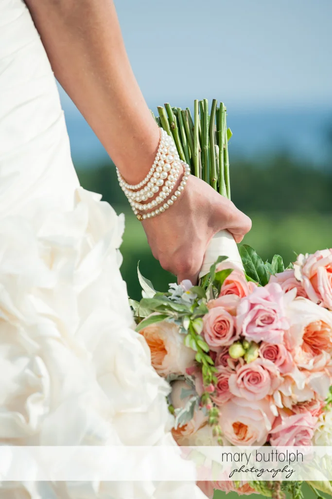 Close up shot of the bride's pearl bracelets and bouquet at the Inns of Aurora Wedding