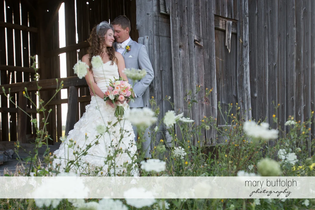 Couple in front of an old barn at the Inns of Aurora Wedding