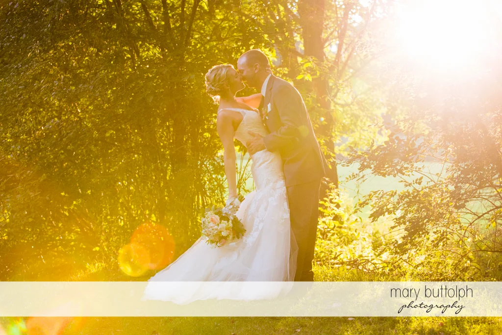 Couple rub noses in the woods at Arrowhead Lodge Wedding