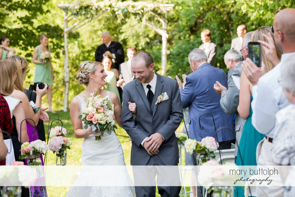 Guests applaud the couple after the wedding ceremony at Arrowhead Lodge Wedding