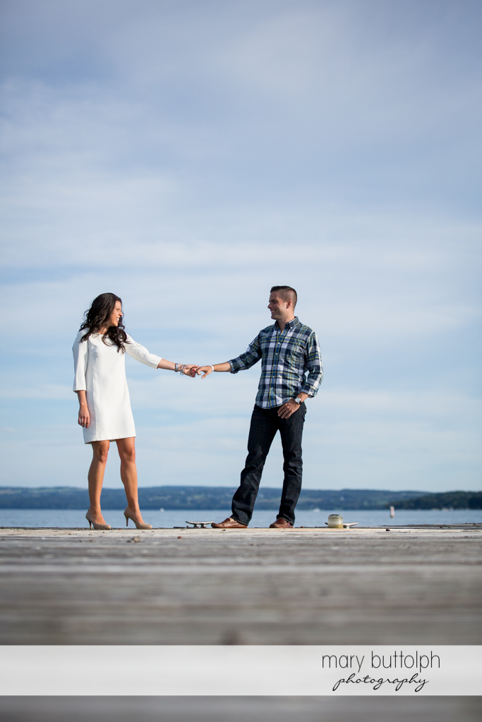 Couple stand in front of the lake at Skaneateles Country Club Engagement