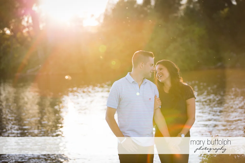 Couple pose in front of the lake at Skaneateles Country Club Engagement