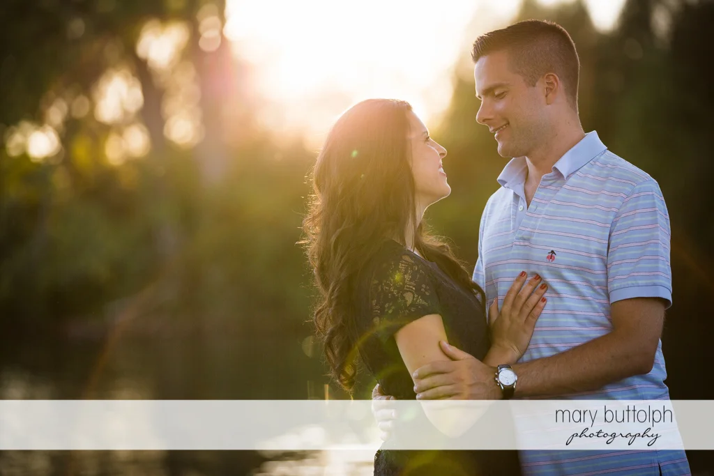 Couple embrace in the garden at Skaneateles Country Club Engagement