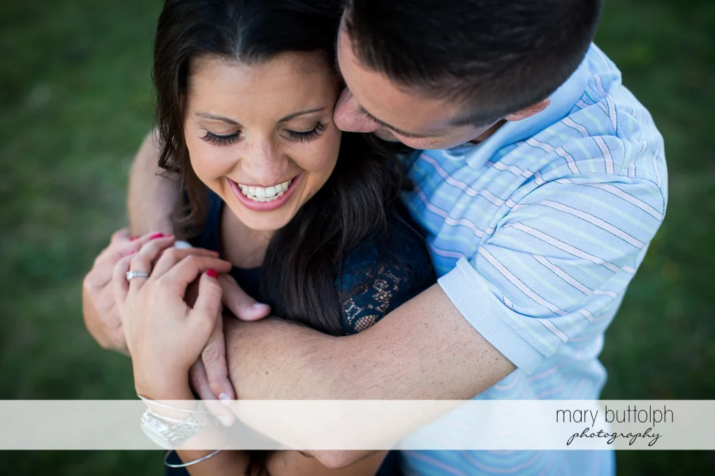 Couple share a happy moment in the garden at Skaneateles Country Club Engagement